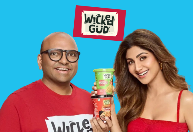 WickedGud promotional graphic featuring fopunder Bhuman Dani and actress Shilpa Shetty holding two cups of WickedGud instant noodles against a light blue background.