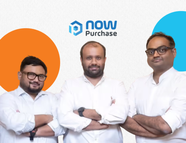 The core leadership team of NowPurchase, including founders Naman Shah and Aakash Shah and CTO Ankan Adhikari, standing side-by-side with folded arms. All three men are wearing white button-down shirts. They are positioned below the 'now Purchase' logo, set against a white background with a decorative orange circle on the left and a light blue circle on the right.